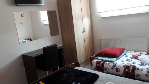 a small bedroom with a bed and a mirror at Hostel IN Club in Zagreb
