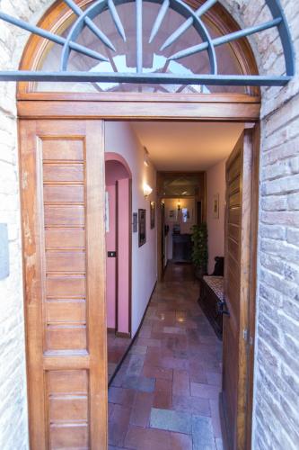 a hallway with a wooden door in a building at Hotel Pallotta in Assisi