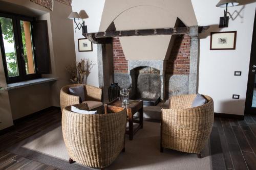 a living room with a table and chairs and a fireplace at Equirelais in Varese
