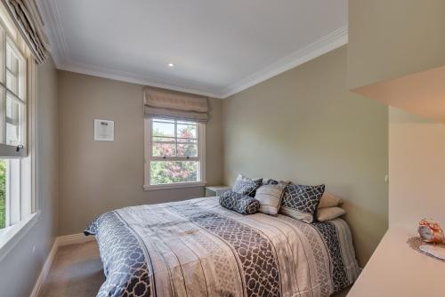 a bedroom with a bed and a window at Bellevue Boutique Lodge in Taupo