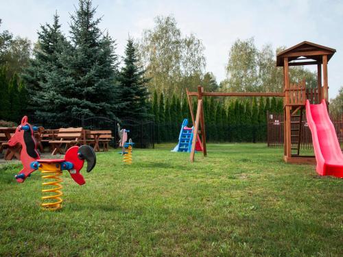 a park with a playground with slides and a swing set at Hotel Restauracja Autos in Solec Kujawski