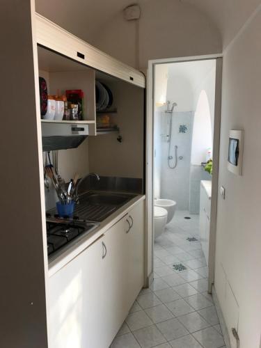a kitchen with a sink and a stove at Suite Antimo - Casa Scibetta in Positano