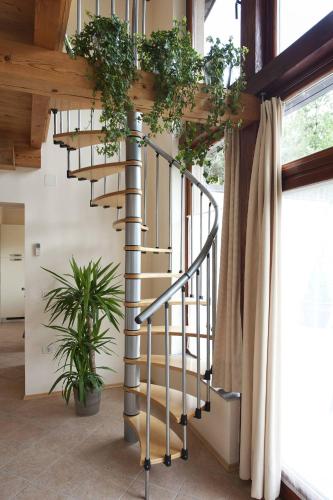 a spiral staircase in a house with plants at Apartments Pri nas in Kobarid
