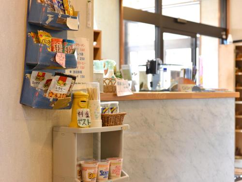 a counter in a store with some food on a shelf at Hotel Shibataya in Kurihara