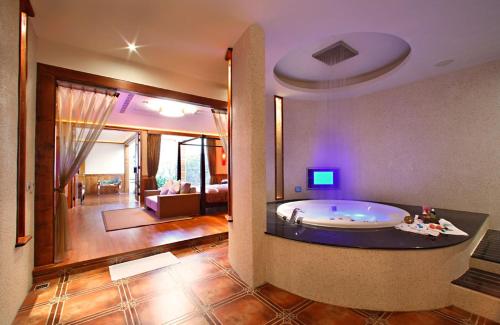 a large bathroom with a tub in the middle of a room at Le chateau Motel in Zhushan