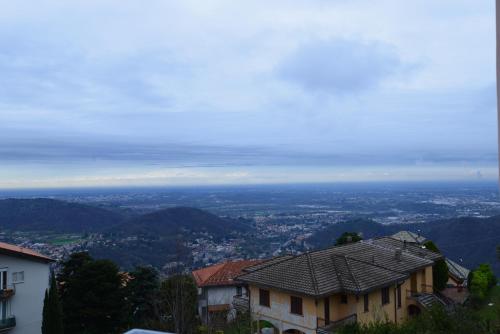 a view of a city from a hill with houses at Locanda Milano 1873 in Brunate