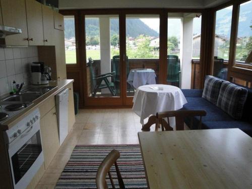 a kitchen with a table and a dining room with a table at Gästehaus Brindlinger in Zell am Ziller