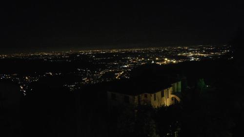 a view of a city at night at Locanda Milano 1873 in Brunate