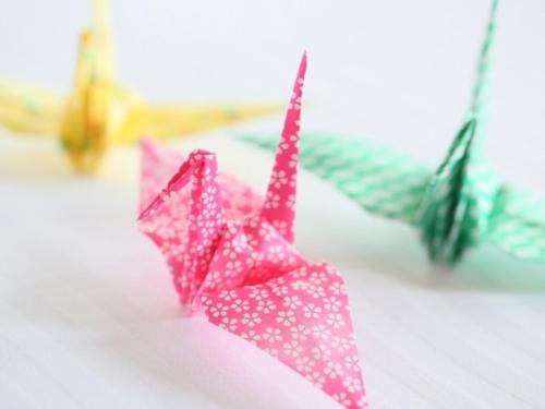 two pink origami umbrellas sitting on a table at APA Hotel Nagoya Sakae Higashi in Nagoya