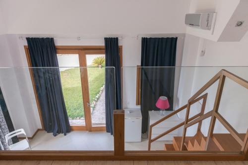 a living room with a staircase and a window at Lalena's Garden in Portopalo