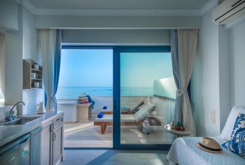 a kitchen with a large glass door leading to a patio at Pyrgos Blue in Malia