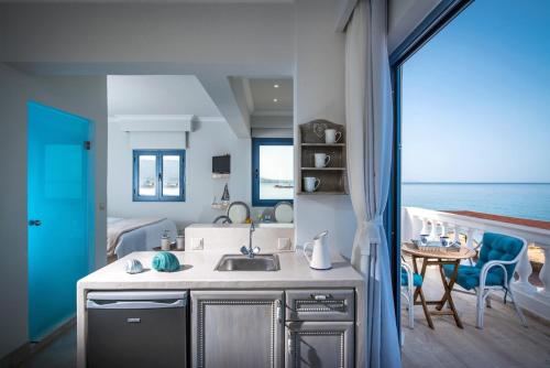 a kitchen with a sink and a view of the ocean at Pyrgos Blue in Malia