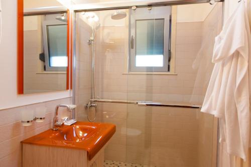 a bathroom with a sink and a shower at Hotel Blue Moon in Ulcinj