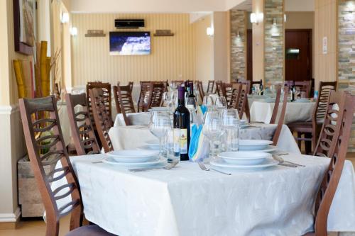 a table with glasses and a bottle of wine on it at Hotel Blue Moon in Ulcinj