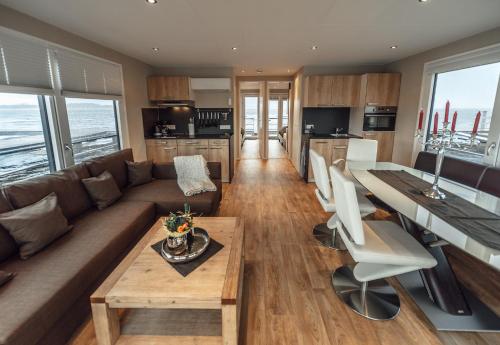 a living room with a couch and a table at Goitzsche Resort in Bitterfeld