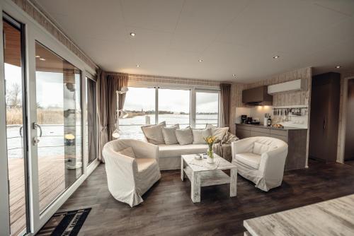 a living room with a couch and chairs and a table at Goitzsche Resort in Bitterfeld