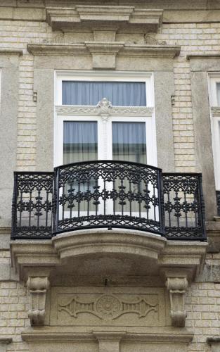 a balcony on the side of a building with a window at Lusitana Hotel in Porto