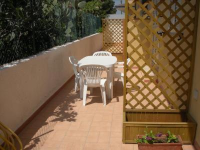 a patio with a table and chairs and a fence at Appartamenti Sul Mare in Avola