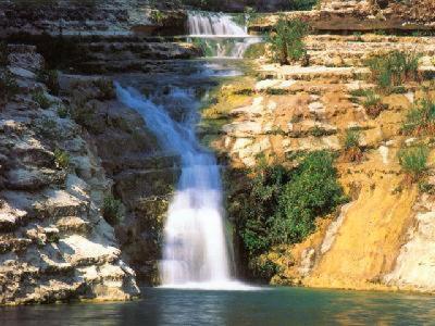 a waterfall in the middle of a river at Appartamenti Sul Mare in Avola