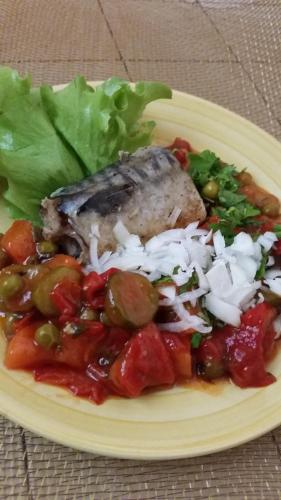 a plate of food with meat and vegetables on a table at Boeritza Hotel Complex in Vladaya