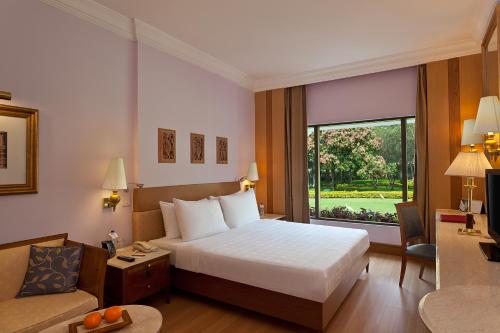 A bed or beds in a room at Trident Bhubaneswar