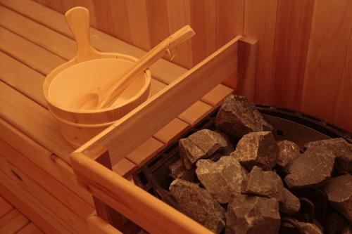 a sauna with a toilet and a pile of rocks at Moty Hotel in Melaka