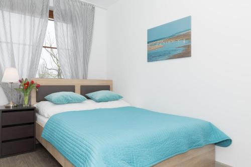 Posteľ alebo postele v izbe v ubytovaní Jantar Apartamenty City Center