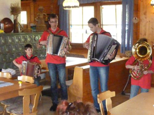 a group of boys playing accordion in a room at Das kleine Berghotel in Liesing