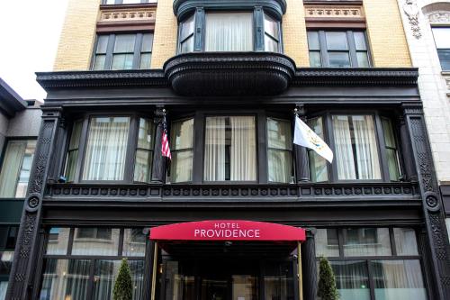 a building with a red sign in front of it at Hotel Providence in Providence