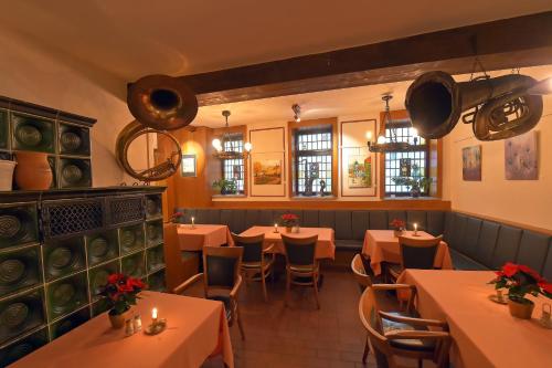 a restaurant with tables and chairs in a room at Gasthaus Zur Noll in Jena