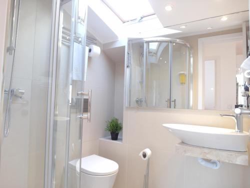 a bathroom with a sink and a toilet and a shower at AlfamaSweethome 1 in Lisbon