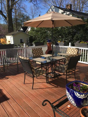 a table and chairs with an umbrella on a deck at The Inn on Front Street in Statesville