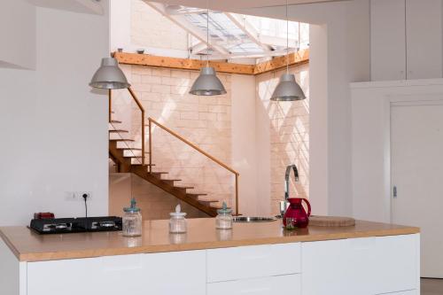 a kitchen with a counter and a staircase at Lalena's Garden in Portopalo
