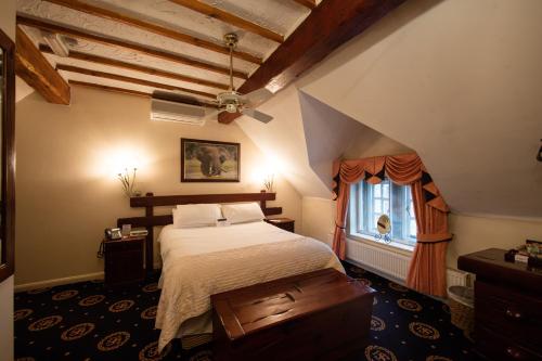 A bed or beds in a room at Santo's Higham Farm Hotel