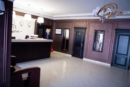 a large room with a kitchen and a lobby at Salute Hotel in Belgorod