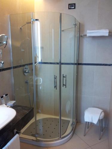 a shower with a glass door in a bathroom at Hotel Excelsior in La Maddalena