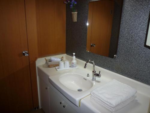 a bathroom with a sink and a mirror at Yudanaka Tawaraya Ryokan in Yamanouchi