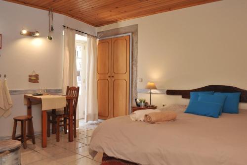 a bedroom with a bed and a table and a desk at 16 Porto Santo Apartments in Porto Santo