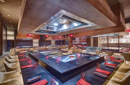 a dining room with a large table and chairs at Royalton Negril, An Autograph Collection All-Inclusive Resort in Negril