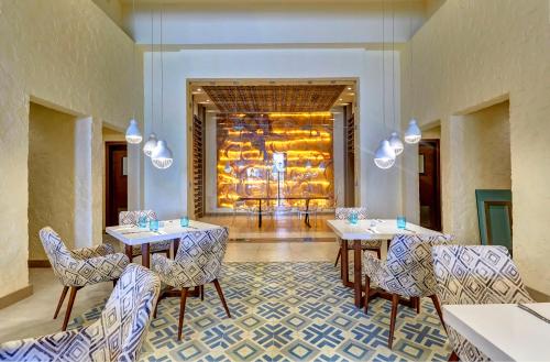 a restaurant with tables and chairs in a room at Royalton Negril, An Autograph Collection All-Inclusive Resort in Negril