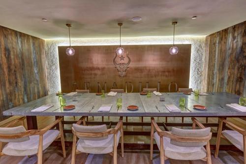a dining room with a large table and chairs at Royalton Negril, An Autograph Collection All-Inclusive Resort in Negril