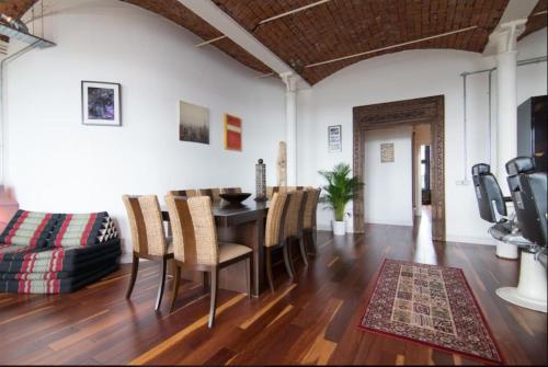 a living room with a dining room table and chairs at Loft Apartment in Port Glasgow