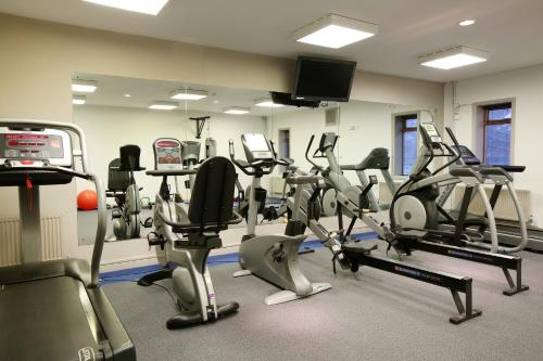 a gym with treadmills and elliptical machines at Hartsfield Manor in Dorking