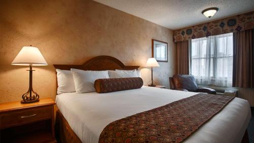 A bed or beds in a room at Best Western Casa Grande Inn