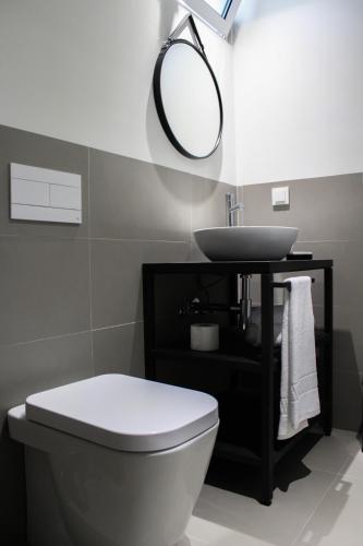 a bathroom with a white toilet and a sink at Apartamentos Turisticos Paraiso in Funchal