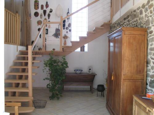 a staircase in a house with a plant in it at Le Peyroux in Teilhet