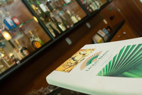 a book sitting on a table in front of a bar at Leques Brasil Hotel Escola in Sao Paulo
