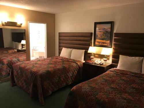 Katil atau katil-katil dalam bilik di Discovery Inn