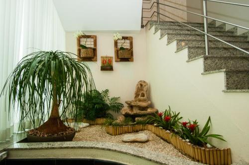 a room with some plants and a staircase at Leques Brasil Hotel Escola in Sao Paulo