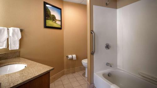 a bathroom with a sink and a tub and a toilet at Best Western Rockland in Rockland